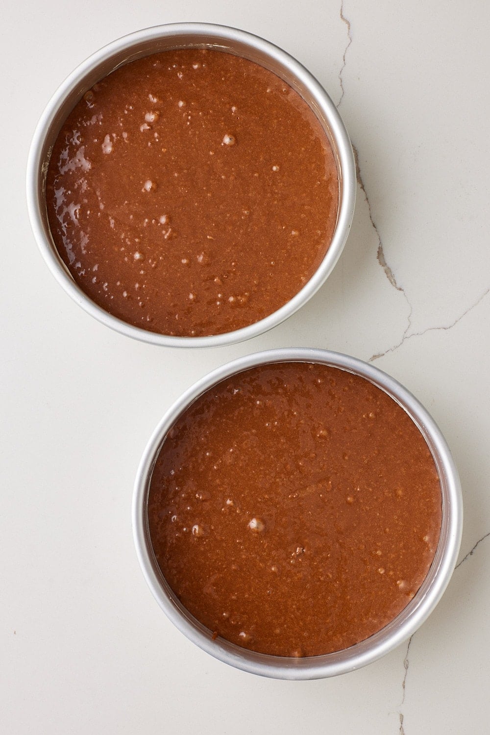 Divide the batter evenly between the prepared pans and smooth the tops.
