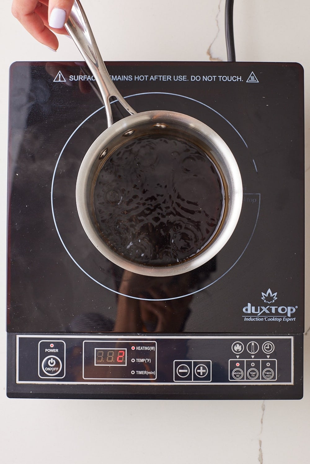 Simmer Coca Cola on the stove. 