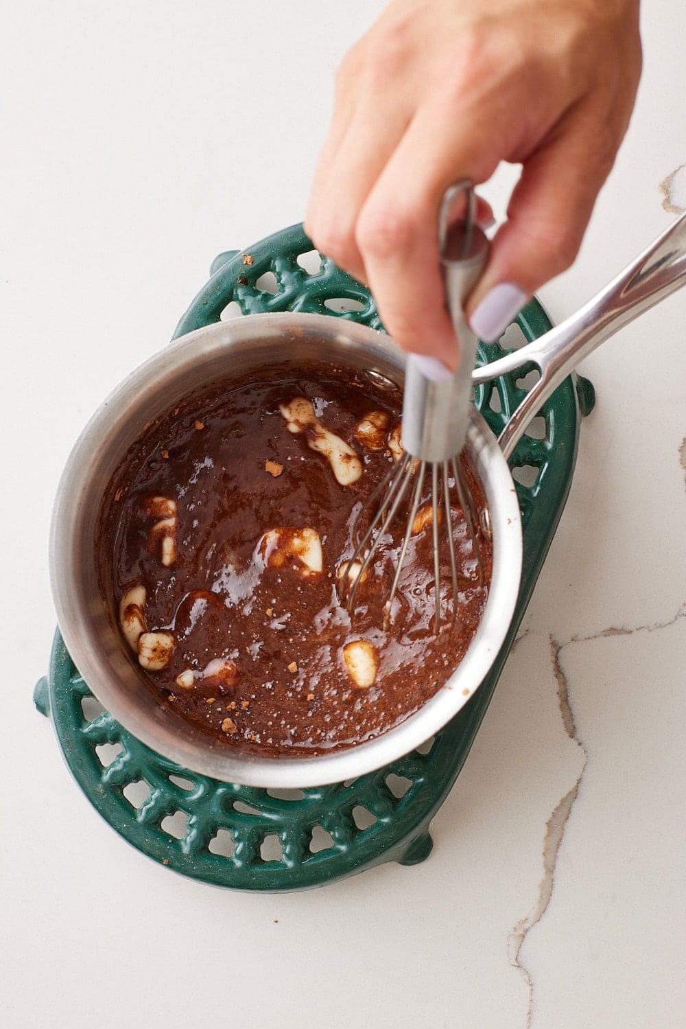 Remove from the heat and whisk in the butter, powdered sugar, and cocoa powder until smooth.