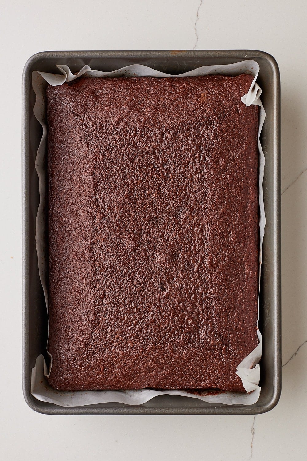 Top-down view of a baked Coca Cola Cake in the baking tray. 