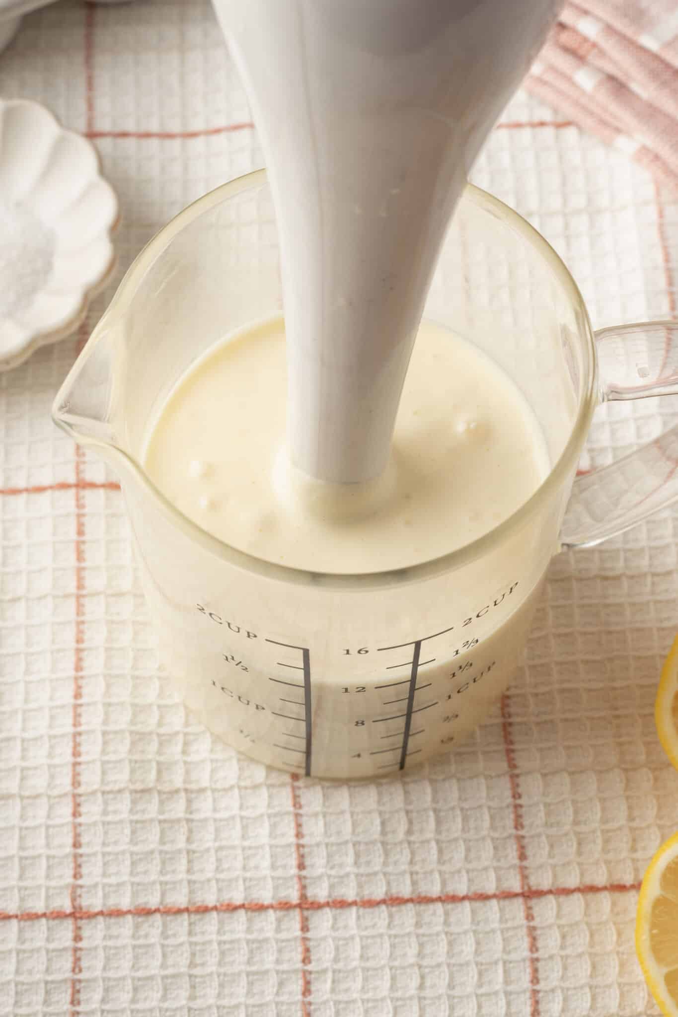 Homemade Mayonnaise2 Blend homemade mayonnaise ingredients with an immersion blender in a jug.