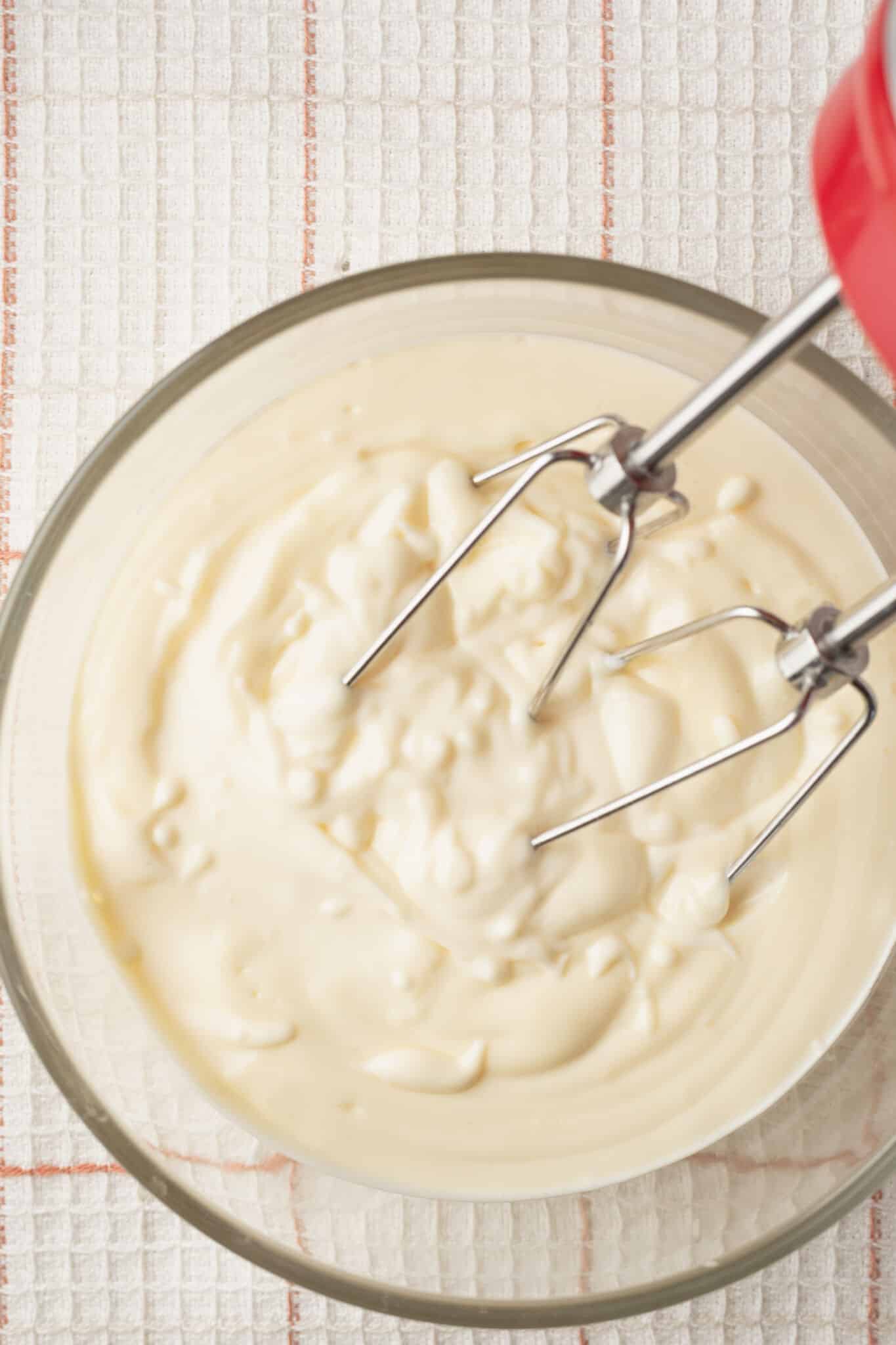 Homemade Mayonnaise4 Top-down view of a bowl of mayonnaise made with a handheld mixer.