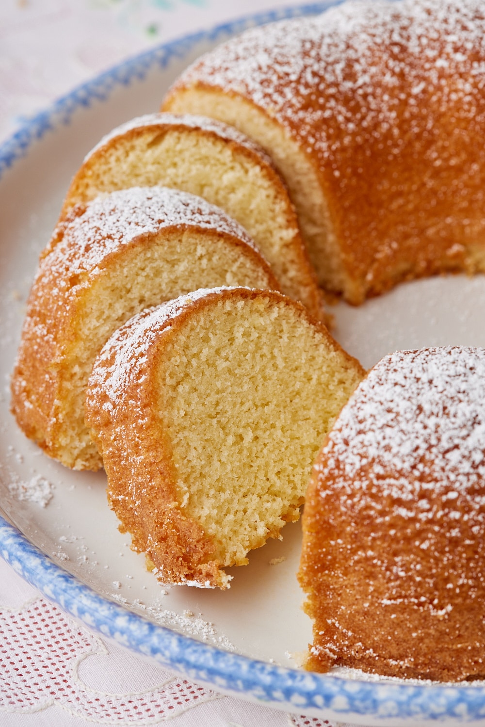 A close-up shot at the sliced Hot Milk Cake shows its moist crumb. 