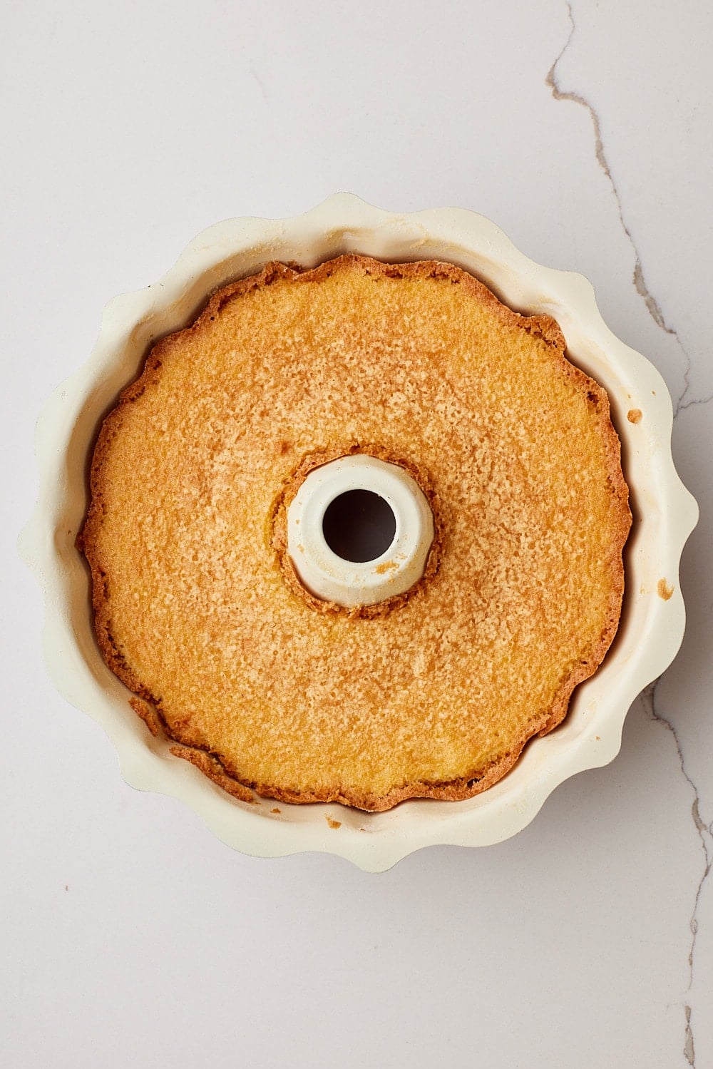 Top-down view of a golden baked Hot Milk Cake. 