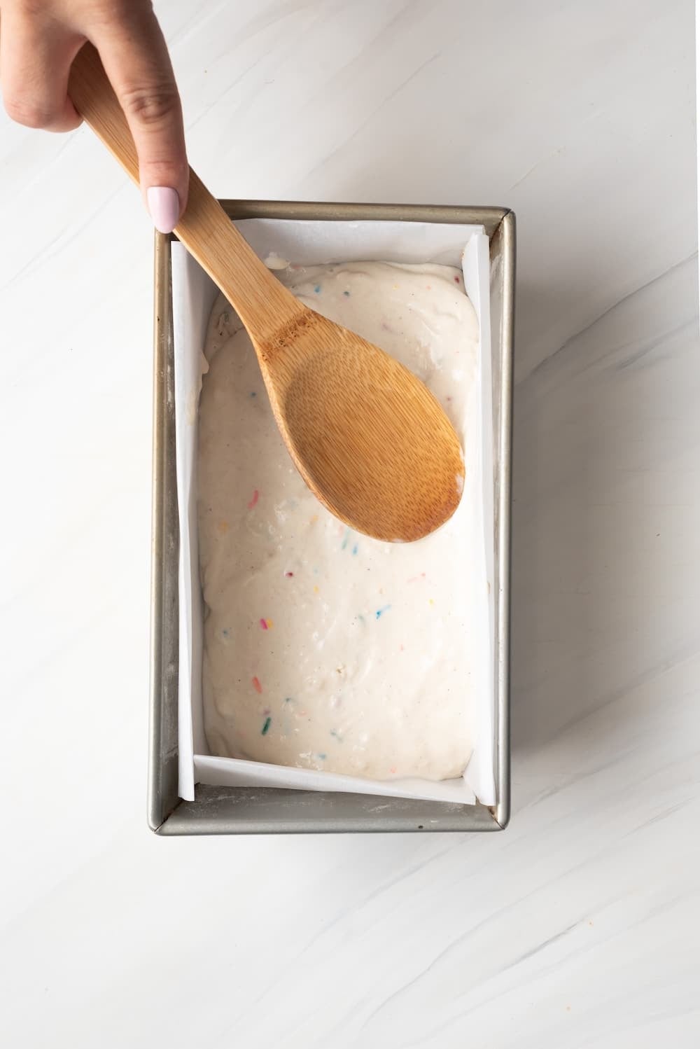 Add Ice Cream Bread batter to the pan and spread it evenly. 