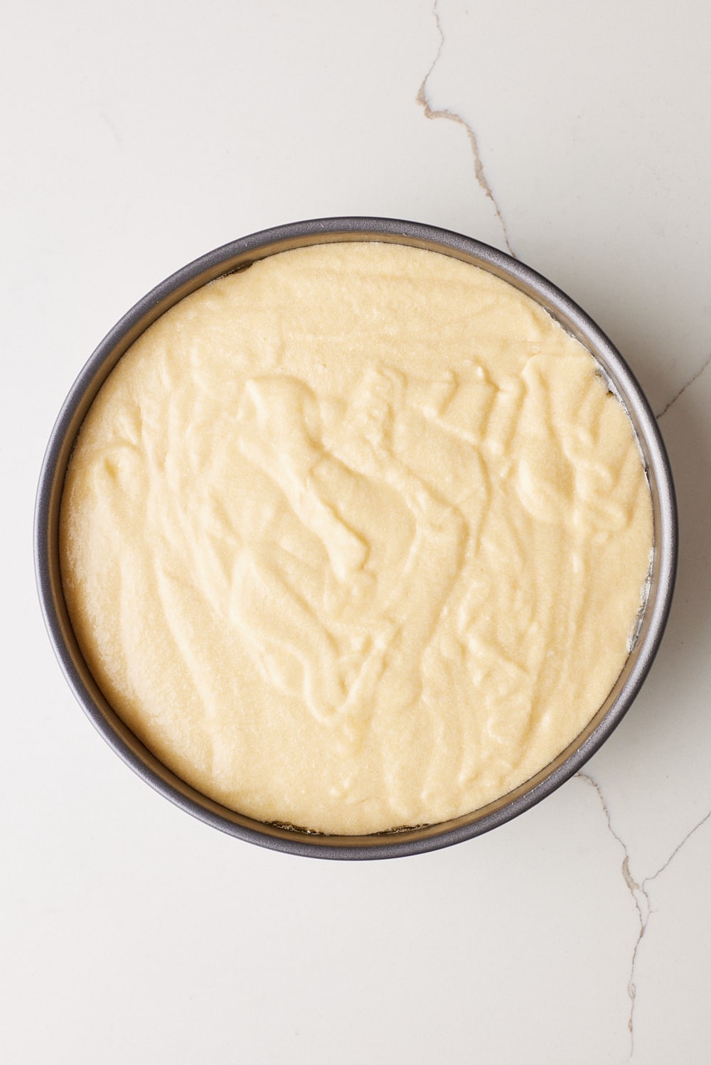 Gently spread the batter evenly over the peaches.