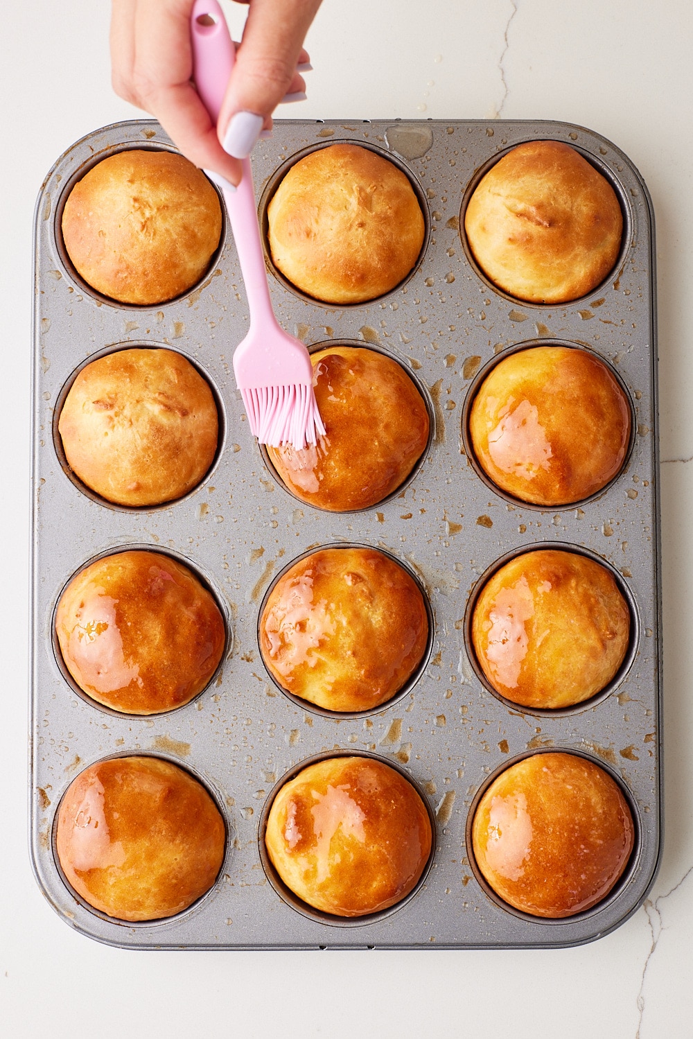 Brush butter on baked golden buns. 