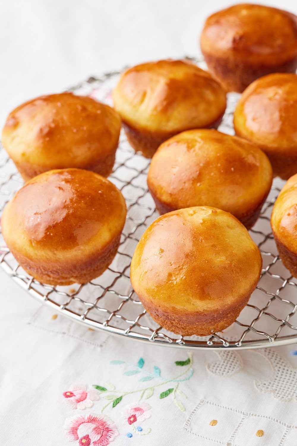A close-up shot at golden Sally Lunn Buns on the rack. 