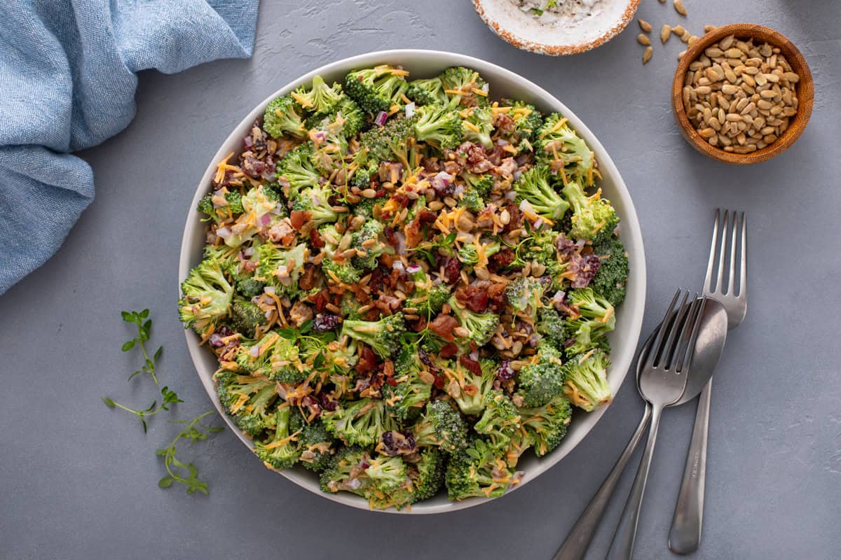 Overhead view of a large serving bowl filled with broccoli cranberry salad on a countertop.