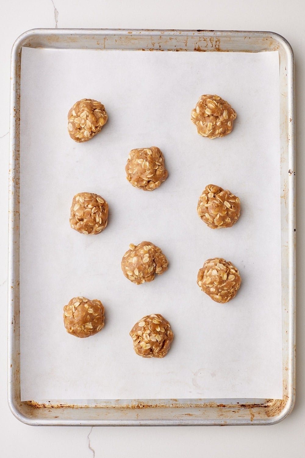 Scooped browned butter cookie dough balls on a baking tray. 
