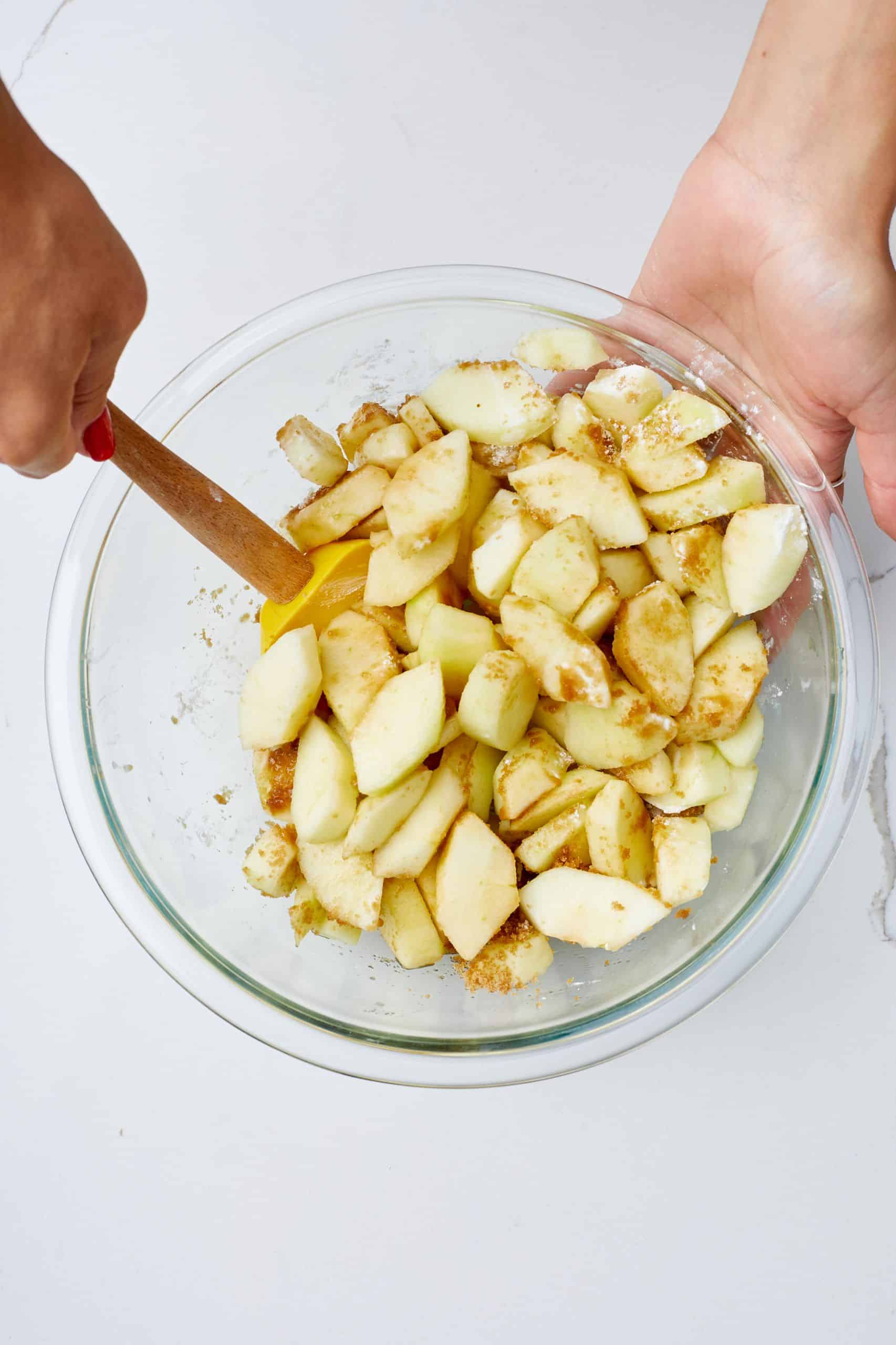 Step-by-step instructions of how to make Traditional Apple Pie: In a large bowl mix chopped apples with cornstarch, brown sugar, and vanilla. Mix well together.
