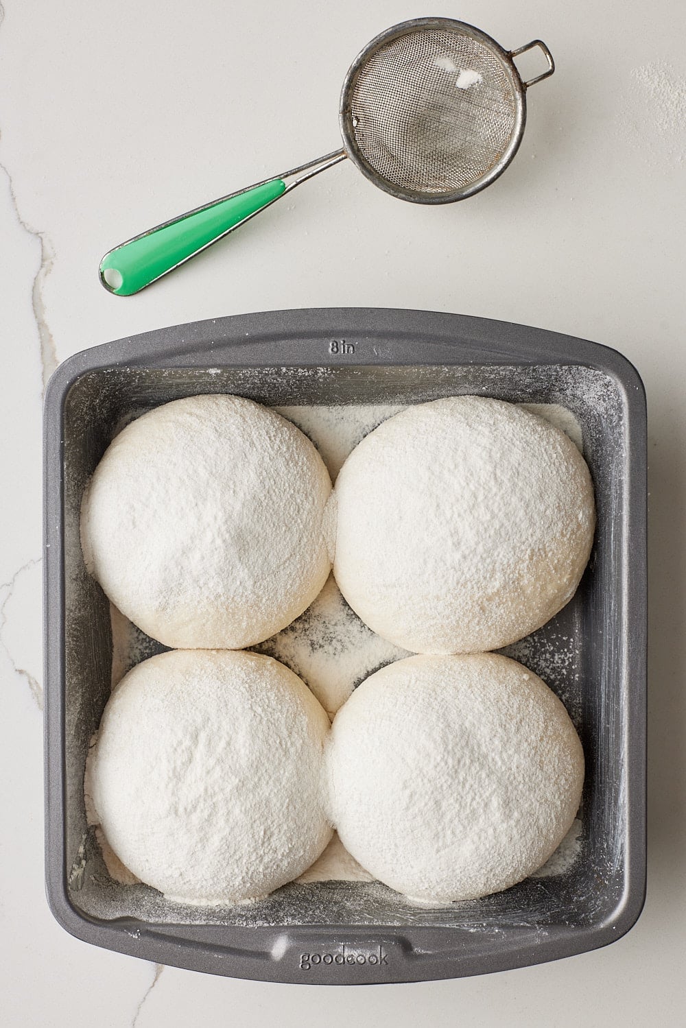 Four roll dough balls are placed in the pan with seam side down. 