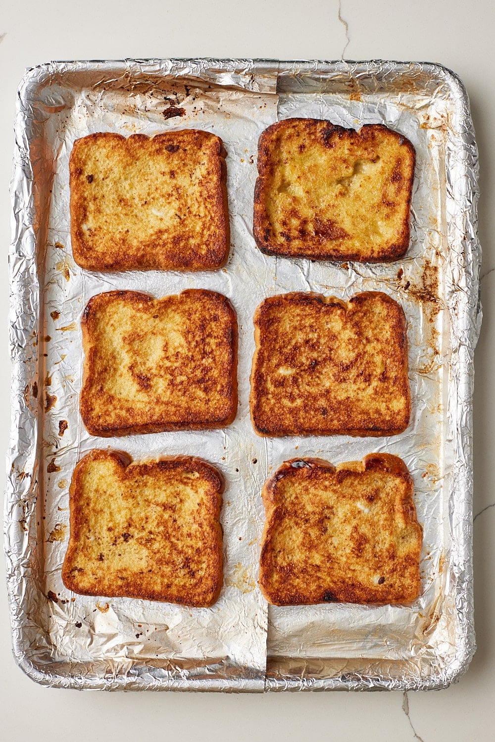 Top down view of Sheet Pan French Toast baked until the tops are golden brown.